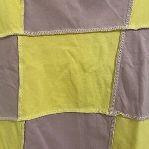 This shirt is in a size Medium, from forever 21, in color yellow & purple
